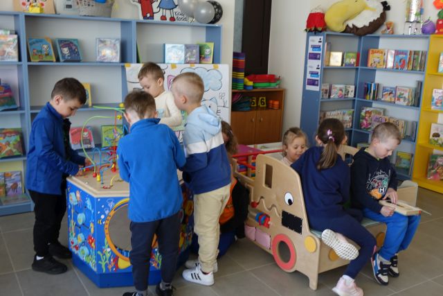 dzieci bawią się na aucie sensorycznym i stoliku sensorycznym