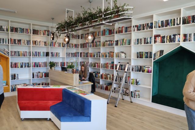 białe regały z książkami, przed kolorowy box