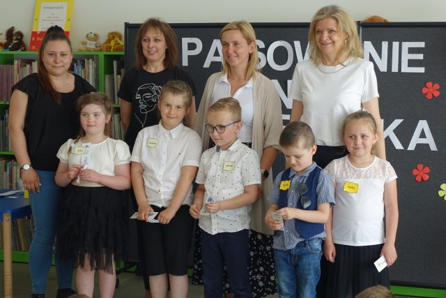 5 dzieci pozuje do zdjęcia z 2 bibliotekarkami i 2 przedszkolankami