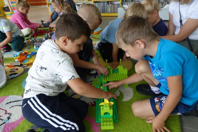 dzieci układają z klocków LEGO