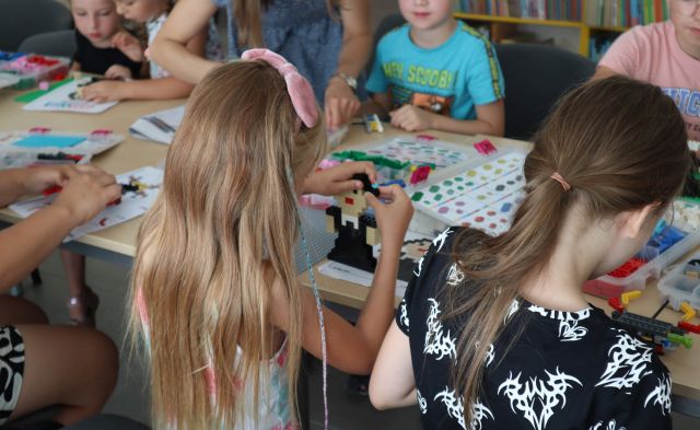 dzieci ukłądają klocki LEGO