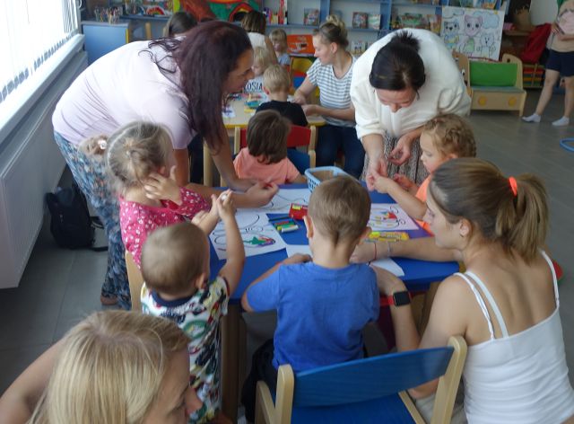 dzieci z pomocą rodziców wyklejają plasteliną narysowane na kartkach zwierzęta