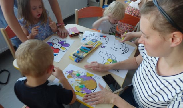 dzieci z pomocą rodziców wyklejają plasteliną narysowane na kartkach zwierzęta