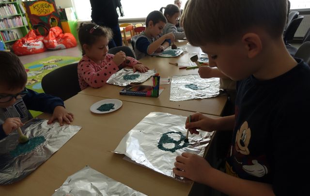 dzieci pacają farbą po foliii aluminiowej