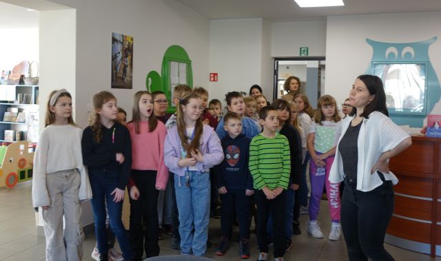 uczniowie oglądają pomieszczenia biblioteczne