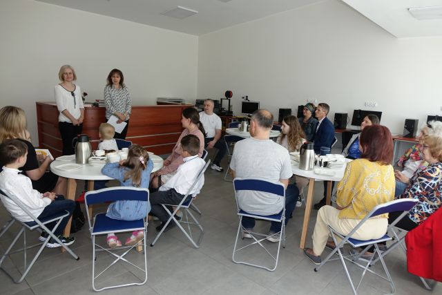 w sali komputerowej przy okrągłych białych stolikach siedzą laureaci konkursu, przed nimi stoi dyrektorka biblioteki i bibliotekarka