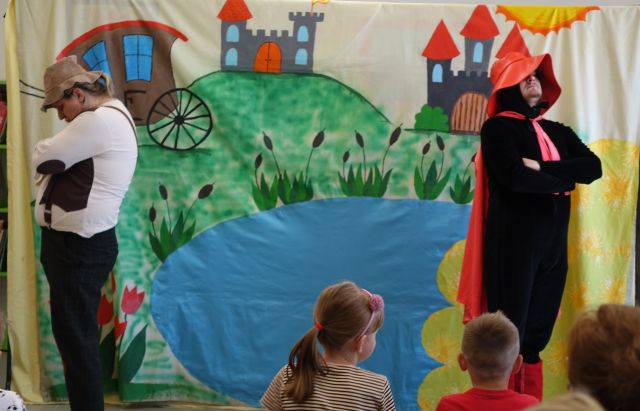 aktor przebrany za kota w butach stoi tyłem do aktora przebranego za młynarza