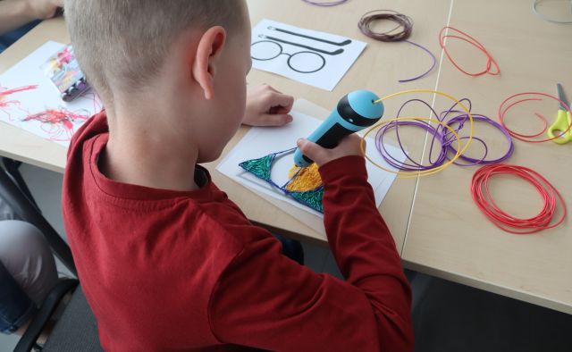 chłopiec koloruje kartkę długopisem 3d