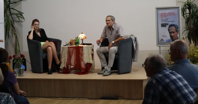 aktor i prowadząca spotkanie siedzą na scenie