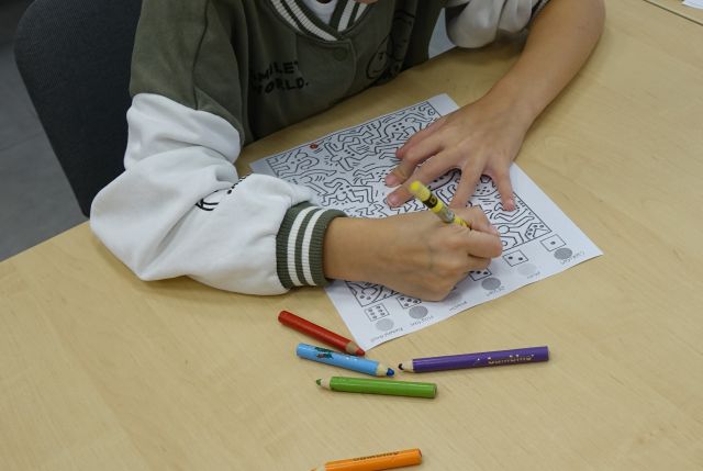 dziewczynka zakolorywuje obrazki