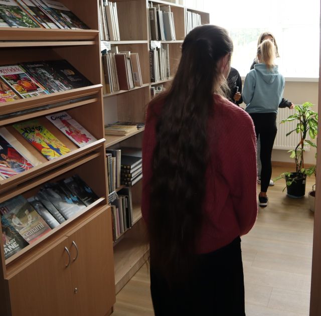 młodzież pomiędzy regałami z książkami