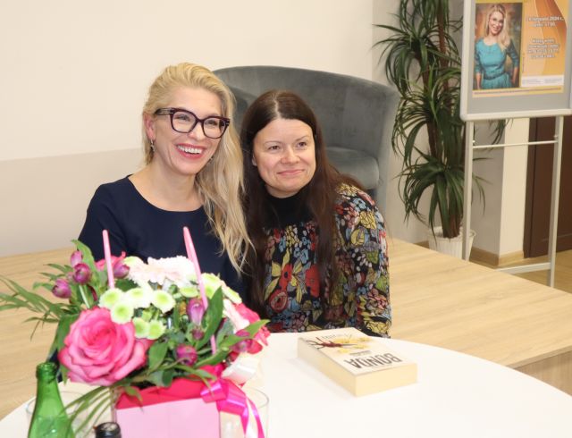 uczestniczka spotkania pozuje do zdjęcia z pisarką