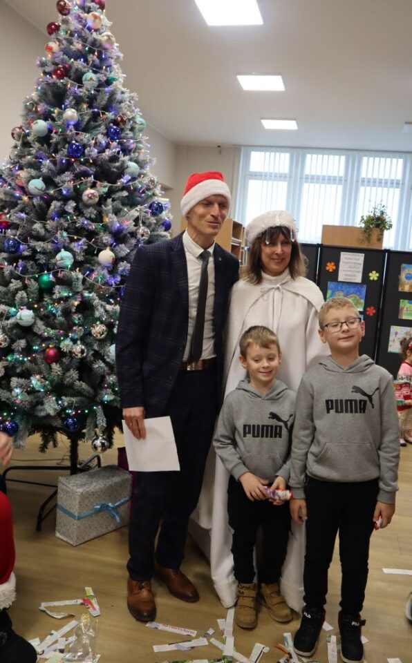 dwóch chłopców pozuje do zdjęcia z burmistrzem i panią zimą