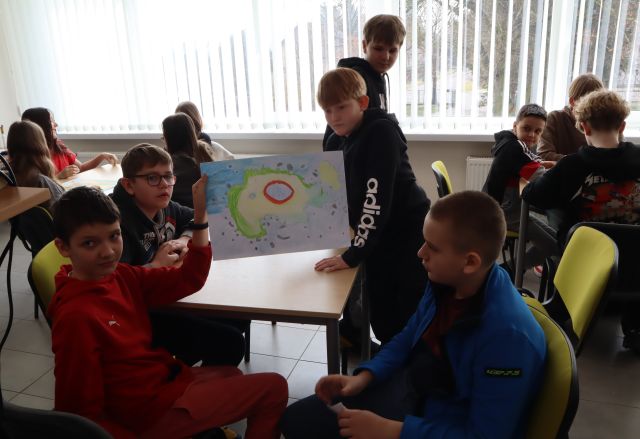 chłopcy prezentują swoją pracę, pozostali uczniowie siedzą przy stołach