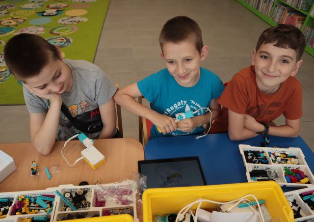 3 chłopców buduje z klocków LEGO