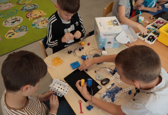 chłopcy budują z klocków LEGO