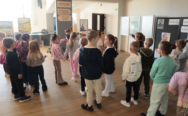 dzieci stoją w holu biblioteki