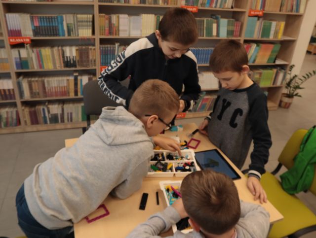 chłopcy budują z klockó LEGO