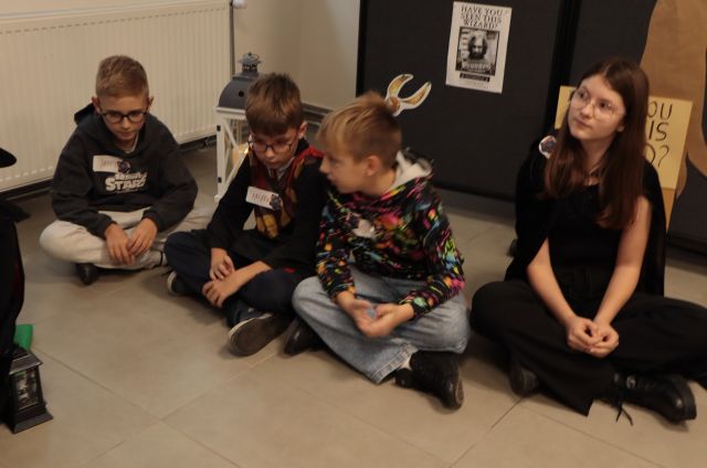 dzieci siedzą na podłodze