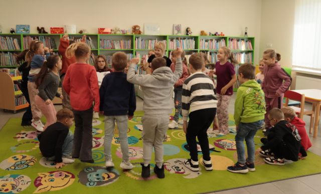 przedszkolaki na kolorowym dywanie wykonują ruchy