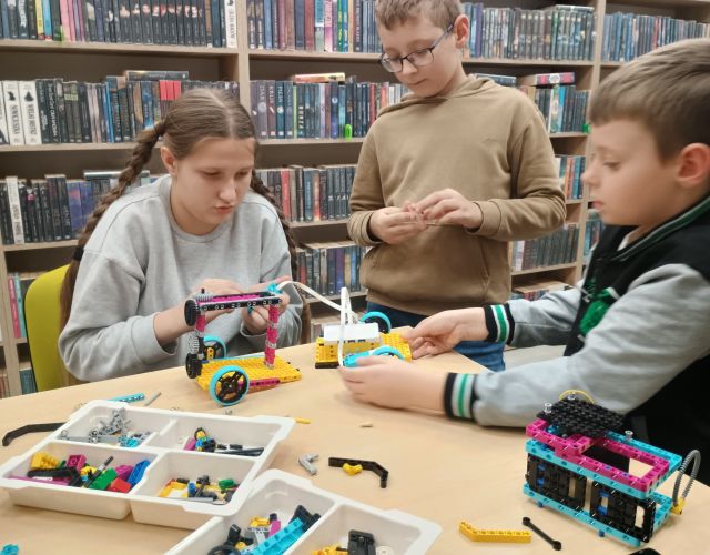 2 chłopców i dziewczynka budują z klocków Lego