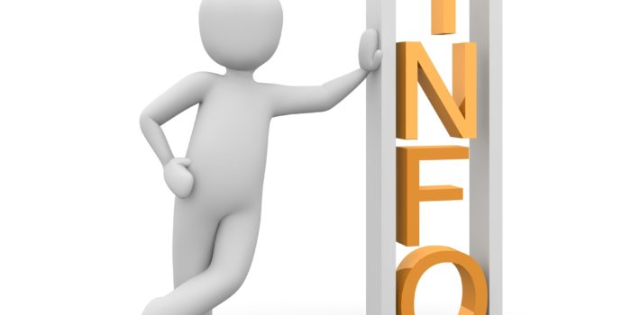 biały ludzik podparty o słupek z napisem Info